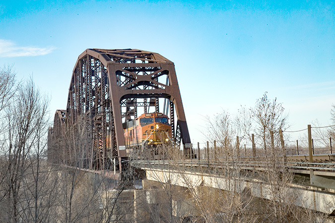 A BNSF train crosses the Missouri River rail bridge between Bismarck and Mandan. A BNSF train crosses the Missouri River rail bridge between Bismarck and Mandan.