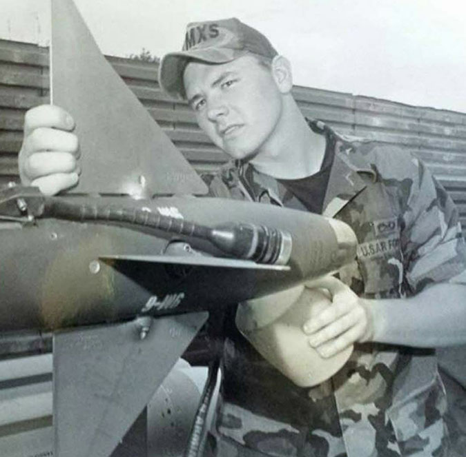 Locke inspects an AIM-9 missile while serving in the Air Force. 