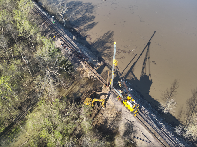 Crews work to replace the washed-out culvert with a bridge. 