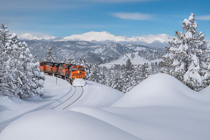 BNSF train passing through a snowy landscape in Colorado. Photo by Erik Lindgren. 