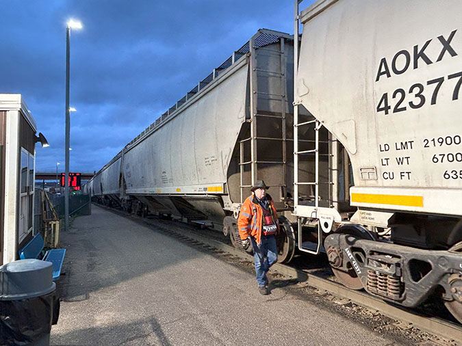 Switchman Lee Flandrich inspects covered hopper cars during the humping process at Northtown. Switchman Lee Flandrich inspects covered hopper cars during the humping process at Northtown.