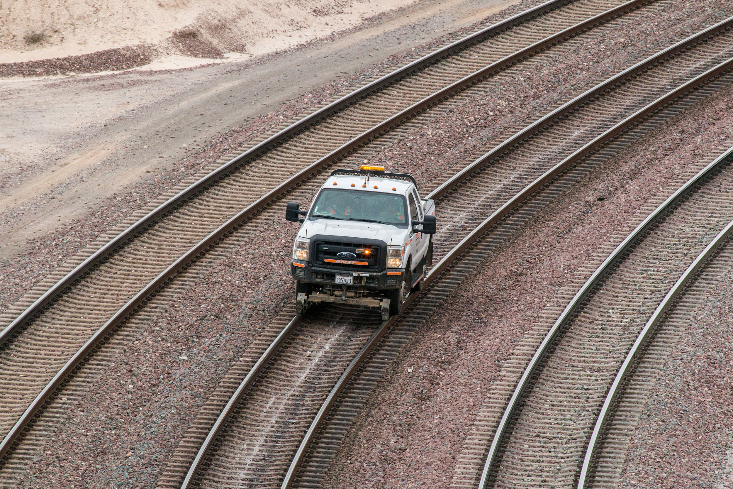 Hyrail vehicles can travel on both train tracks and roads. Hyrail vehicles can travel on both train tracks and roads.