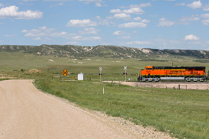 A BNSF train approaches a crossing in Wyoming.